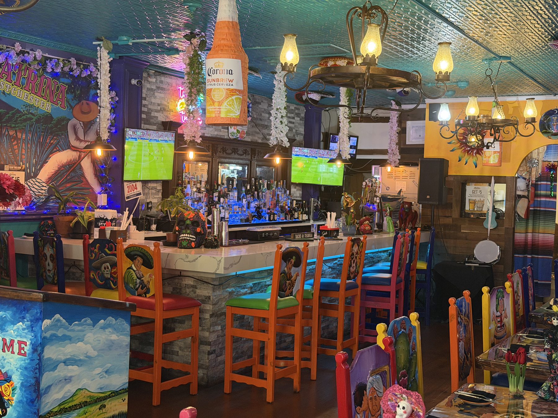 Bar area with string lights and colorful murals