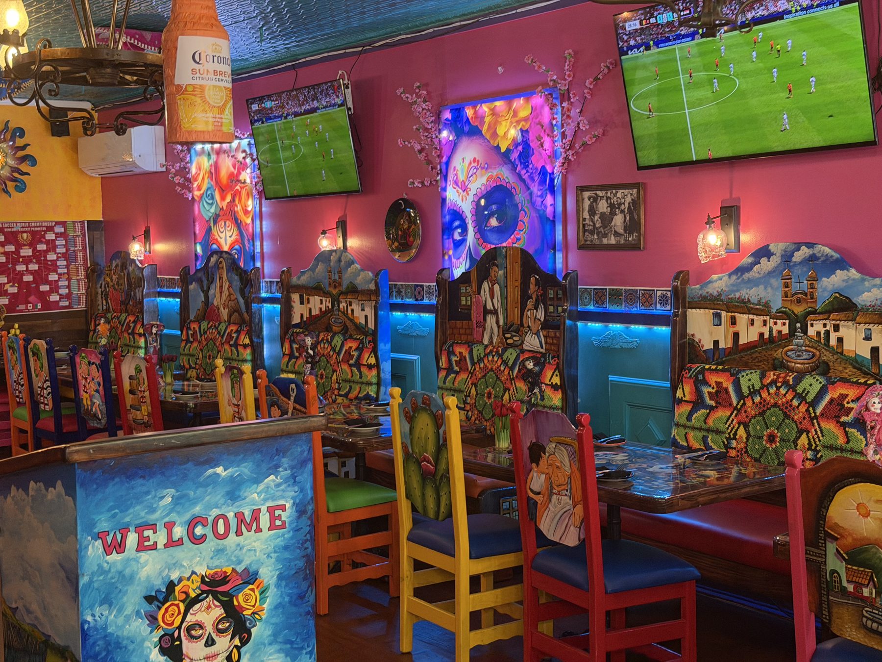 Big screen TVs showing a soccer match inside La Catrina
